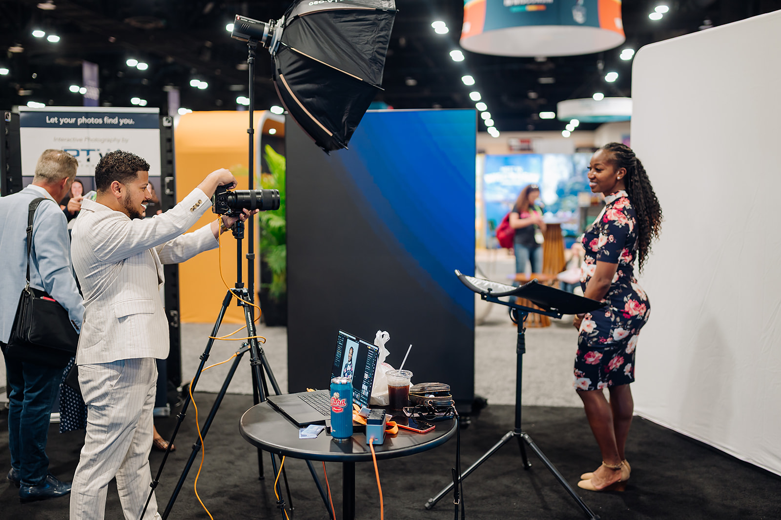RTW photographer directing an attendee at an on-site executive headshot lounge
